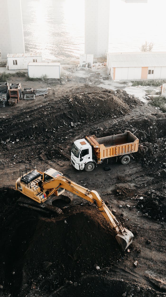 Mastering the First Impression: Your intriguing post title goes here A high angle view of a construction site in Istanbul featuring an excavator and a truck.