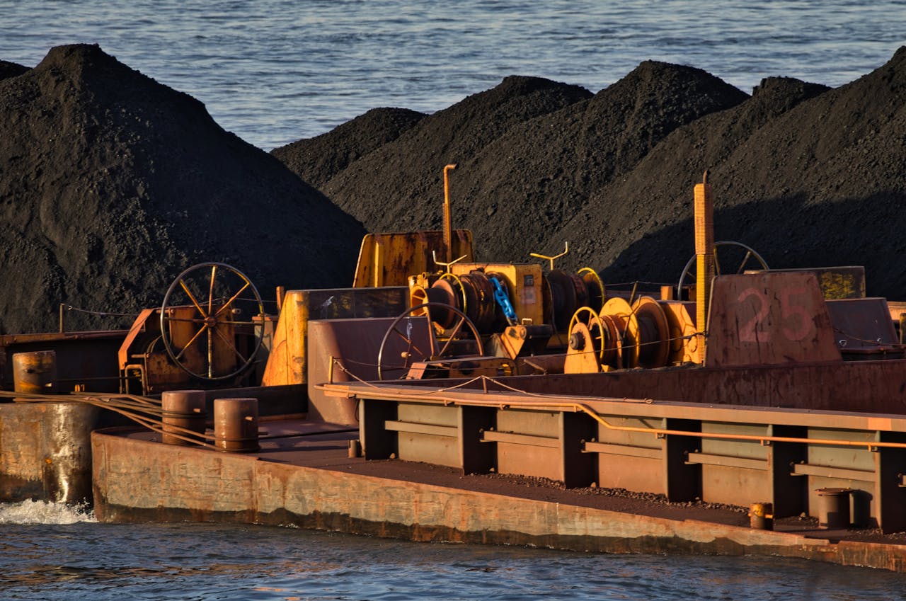 The Art of Drawing Readers In: Your attractive post title goes here A cargo ship carrying coal on a river, showcasing inland waterway transportation and logistics.